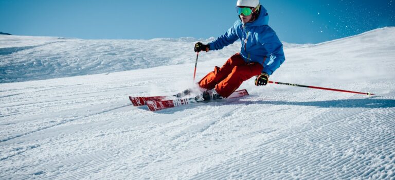 man ice skiing on hill