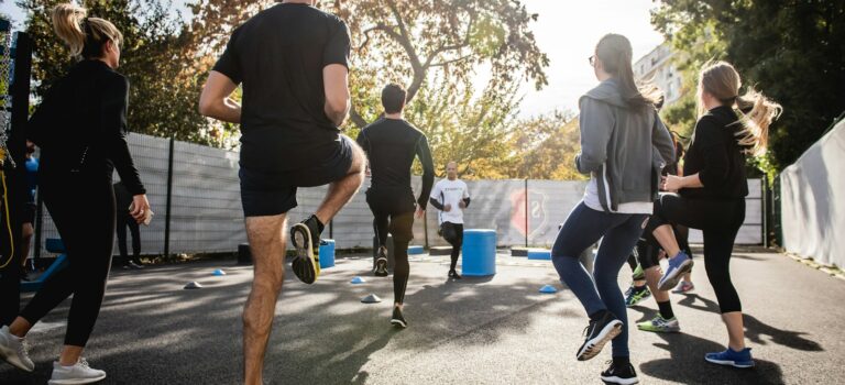 man in black t-shirt and black shorts running on road during daytime